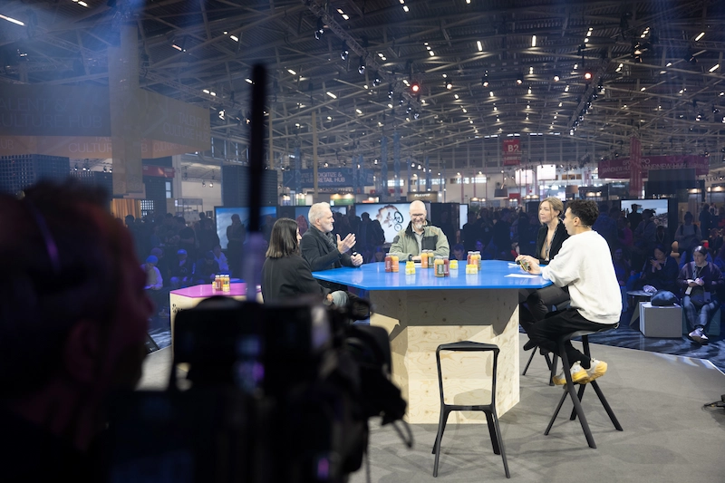 Florian Auger speaking on an ISPO innovation panel alongside leaders from Renault, Dacia, and Polestar.